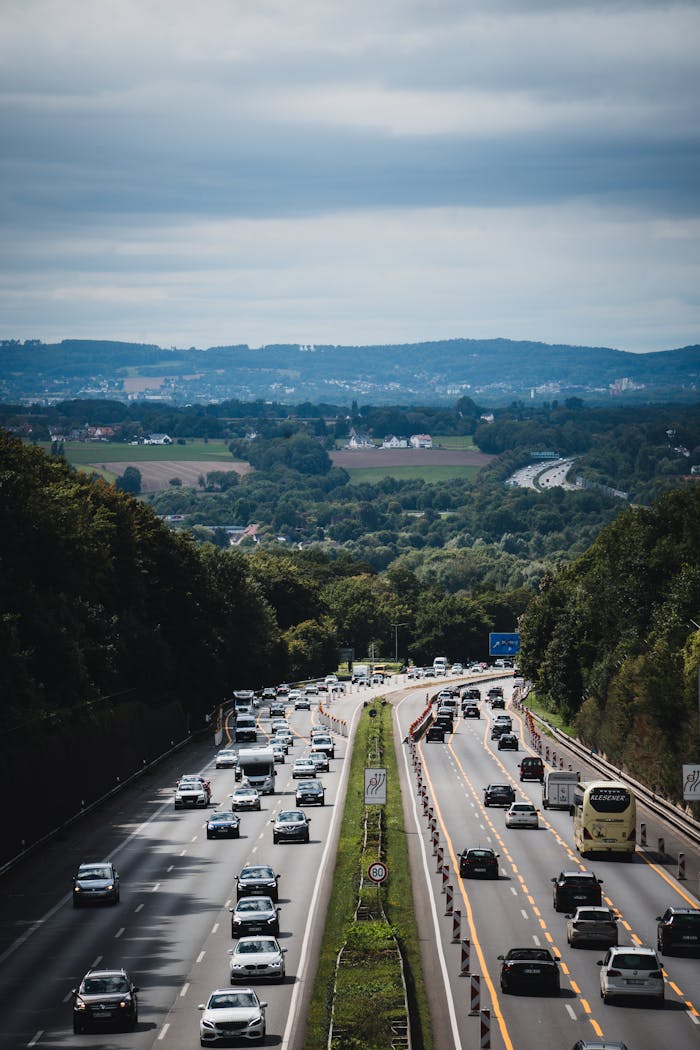 A scenic view of a busy highway in Herford, Germany, surrounded by lush greenery and hills.